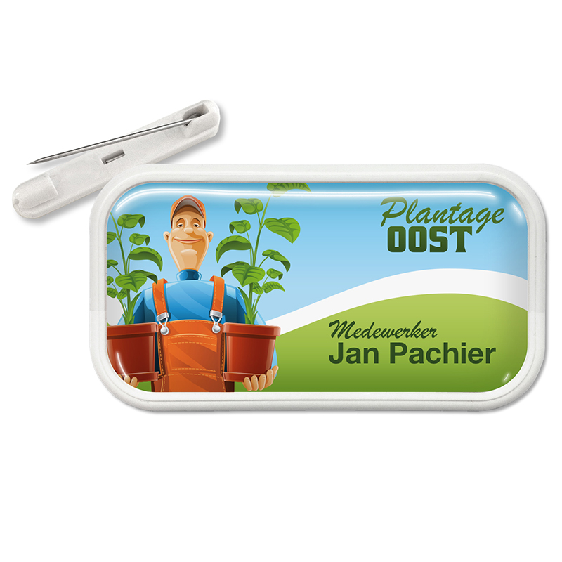 Rechthoekige naambadge van kunststof met dominglabel en speldsluiting. 70 x 35 mm